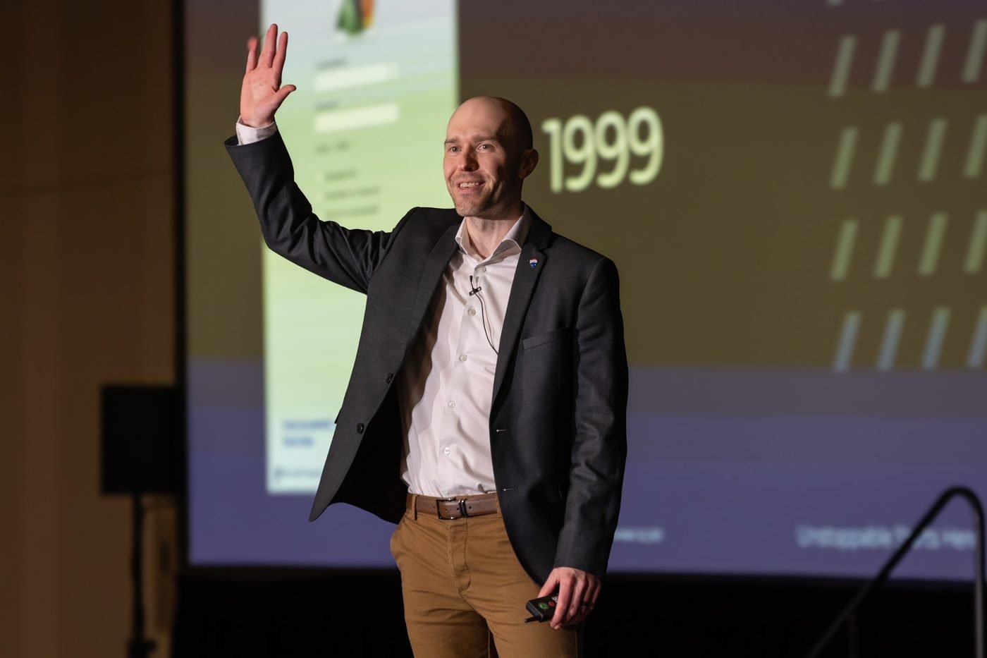 Wade Paterson waving to the audience while presenting